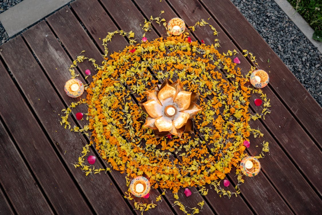 A festive rangoli decoration in yellow and orange.